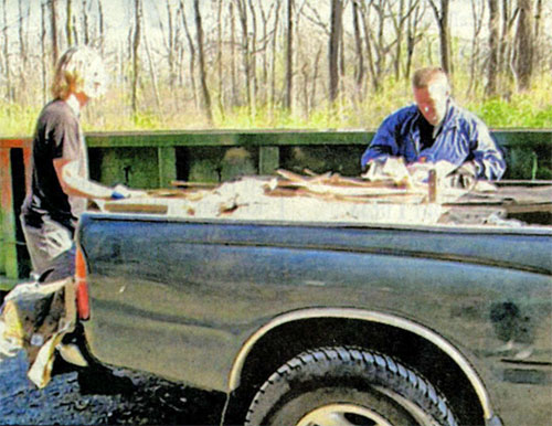 Dave Leibert, left, and Joe Transue removing one of the many loads that was cleaned up on the trails and in the woods at Walking Purchase Park.
