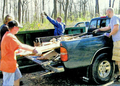 James Benetzky, left, from North Catasauqua, an educa- I tion major at Northampton Area Community College, joins the group. He saw signs at NACC asking for help. Behind I Benetzky is Dave Leibert who is the trail designer for the park. On right behind the truck, is Joe Transue from Danielsville. He has been a member of the Valley Mountain Bikers for five years. On far right is Trevor Lanning from Emmaus. He is the vice president of the club.